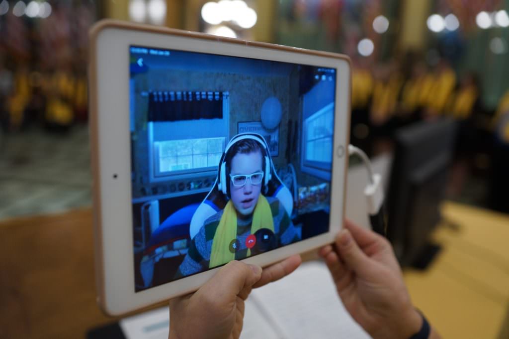 ipad showing student with yellow scarf